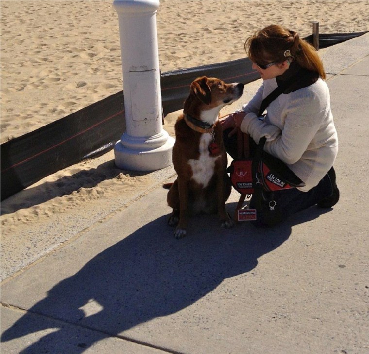At the beach in Ocean City with cochlear implant, hearing aid, and hearing assistance dog